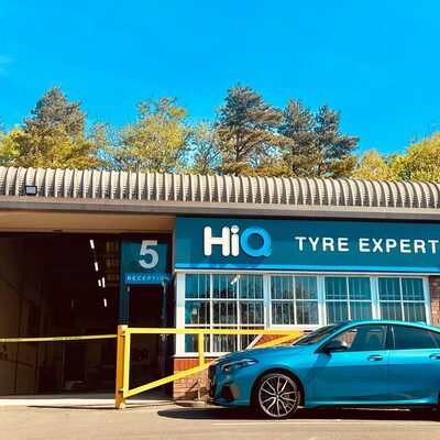 Hi Q Tyre Expert Newcastle with Blue BMW in front