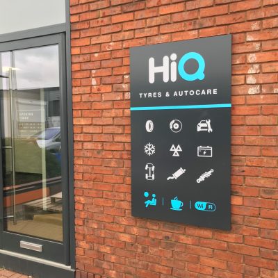 Exterior signage showing main services and facilities at HiQ Enfield