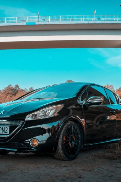 Black Peugeot under bridge