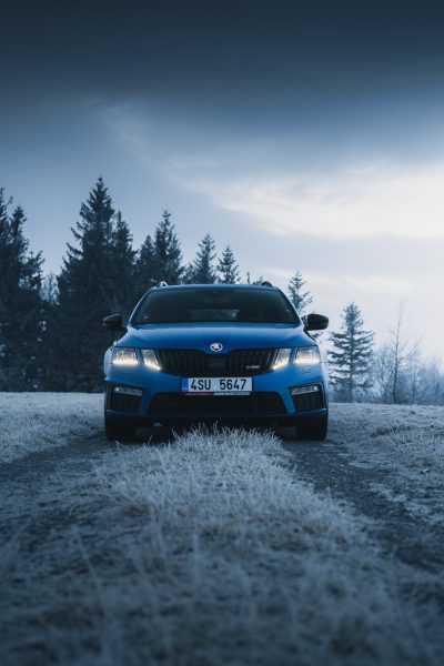 Blue Skoda driving towards Camera through Field